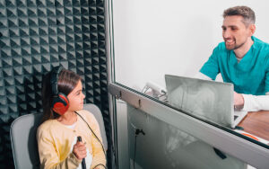 A child performing a hearing test to assess eligibility for cochlear implant surgery.